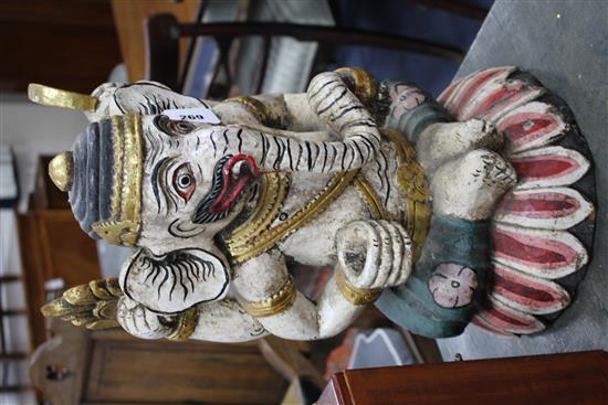 A large painted Balinese wooden kris stand modelled as a seated Ganesh, 20th century, height 51cm